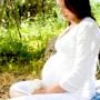 pregnant woman sitting outside